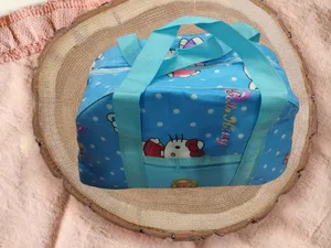 ├é┬áBlue, water-resistant baby diaper bag with an animal and flower pattern.├é┬á
